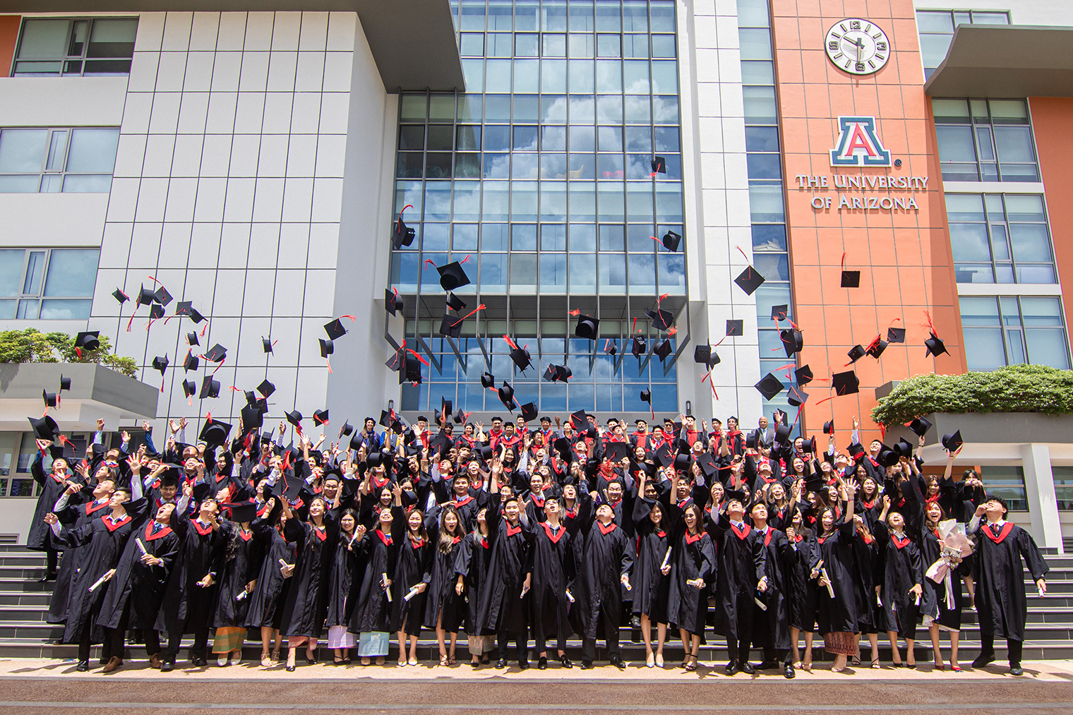 AUPP +Uarizona dual degree graduates throwing their graduation caps in the air