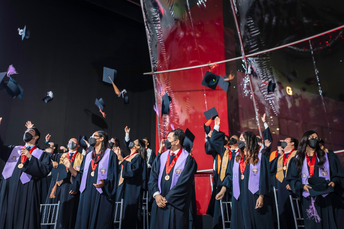 UPC-UArizona students at the May 26 Graduation Ceremony in Lima, Peru throwing their caps in the air