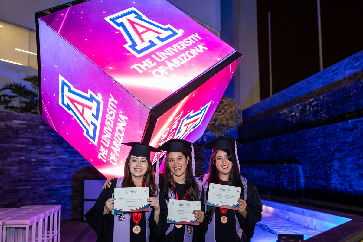UPC-UArizona students at the May 26 Graduation Ceremony in Lima, Peru with a large, lit up Block A