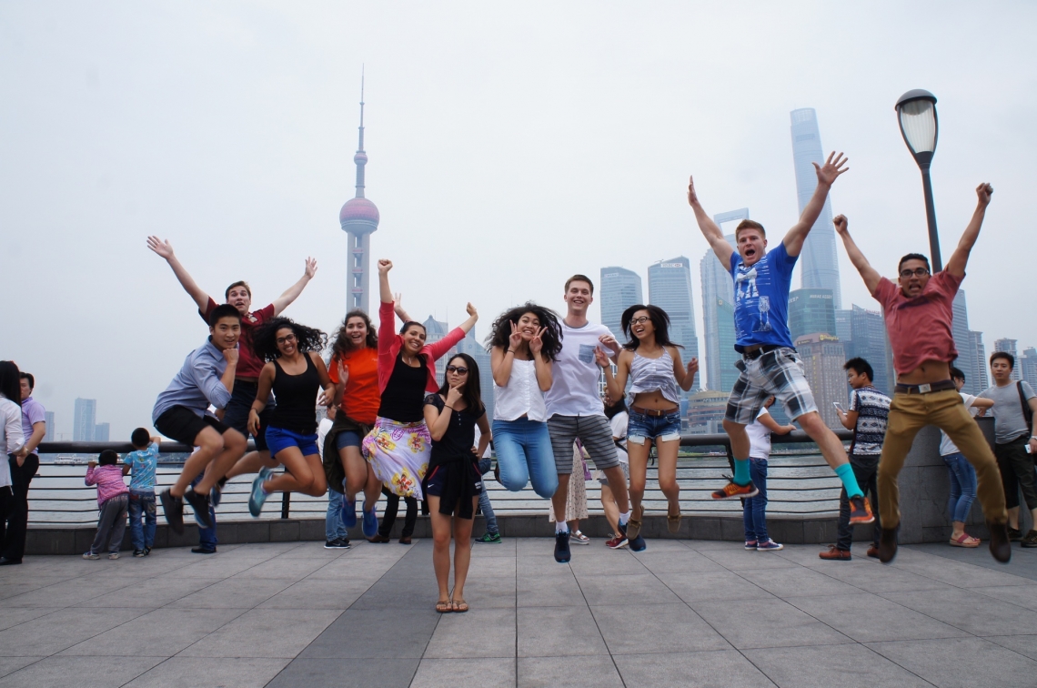 Students in the Arizona-in-Shanghai program, an intensive language and cultural immersion program, celebrate at the Bund, a waterfront area in Shanghai. The skyline of the Pudong financial district is in the background.