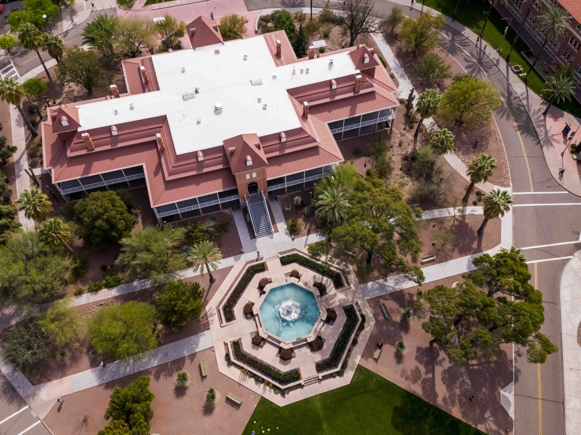Aerial shot over Old Main building with view of the fountain