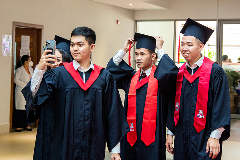 Three students taking a group selfie at the UArizona AUPP Graduation Ceremony June 2022
