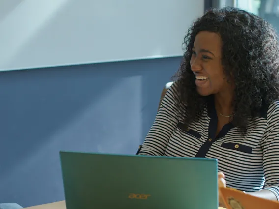 Tina, a Ph.D. student from Nigeria at the College of Public Health, laughs with a professor.