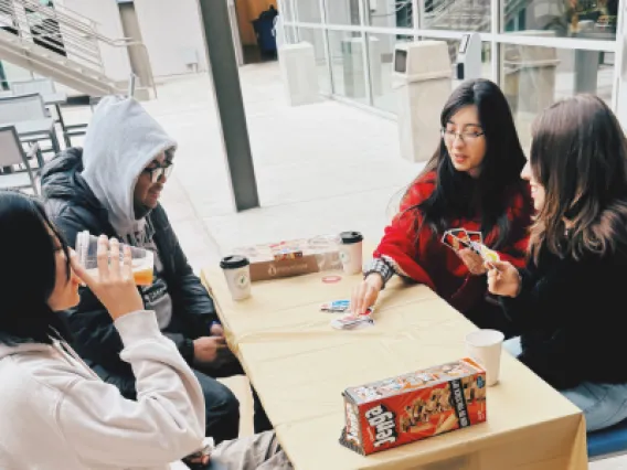 UArizona students playing a card game outside Arizona Global