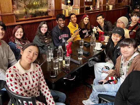 International students gather around a dinner table