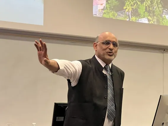 Dr. Bipin Nair in front of a presentation screen