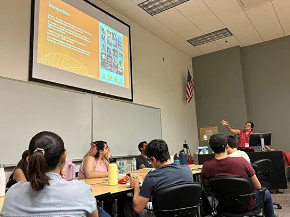 Students sit a table during a classroom presentation