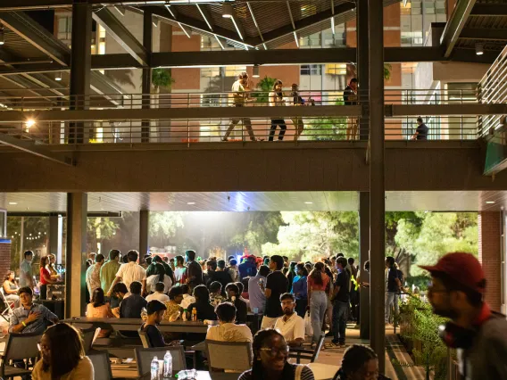 The Global Center patio filled with people sitting and eating.