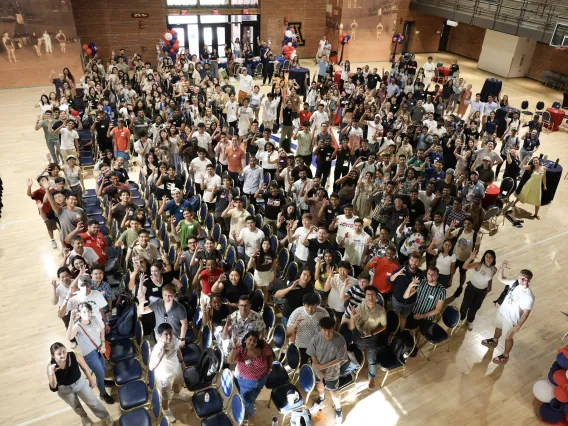 The large international student class poses for a group photo.