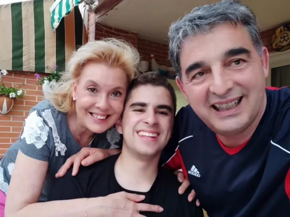 Study Abroad student Aaron takes a selfie with host family