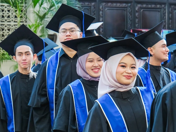 Sampoerna graduates in caps and gowns prepare for the ceremony.