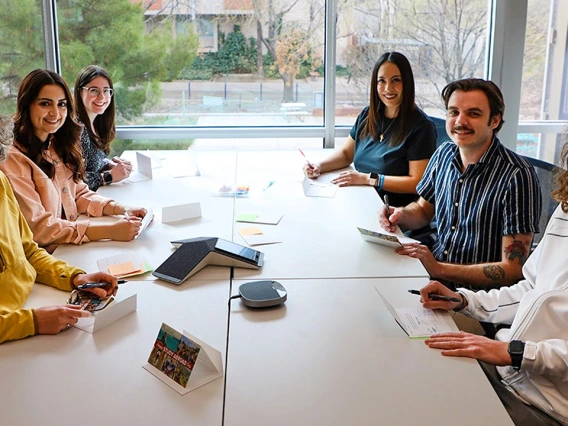 The Study Abroad team sits at a table signing thank you cards.