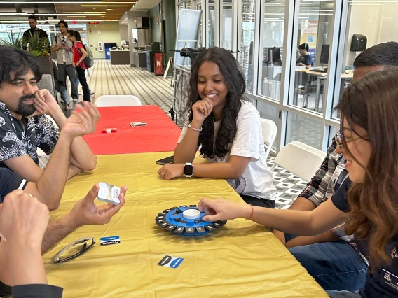 Students play a game around a table