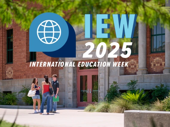 Three students stand talking in front of a historic brick building on the University of Arizona campus, with green trees and plants around them. Overlaid text reads “IEW 2025 International Education Week” with a blue globe logo.