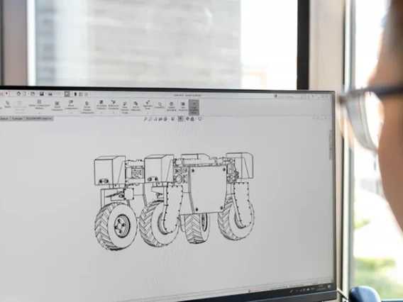 Student creating schematics on a computer