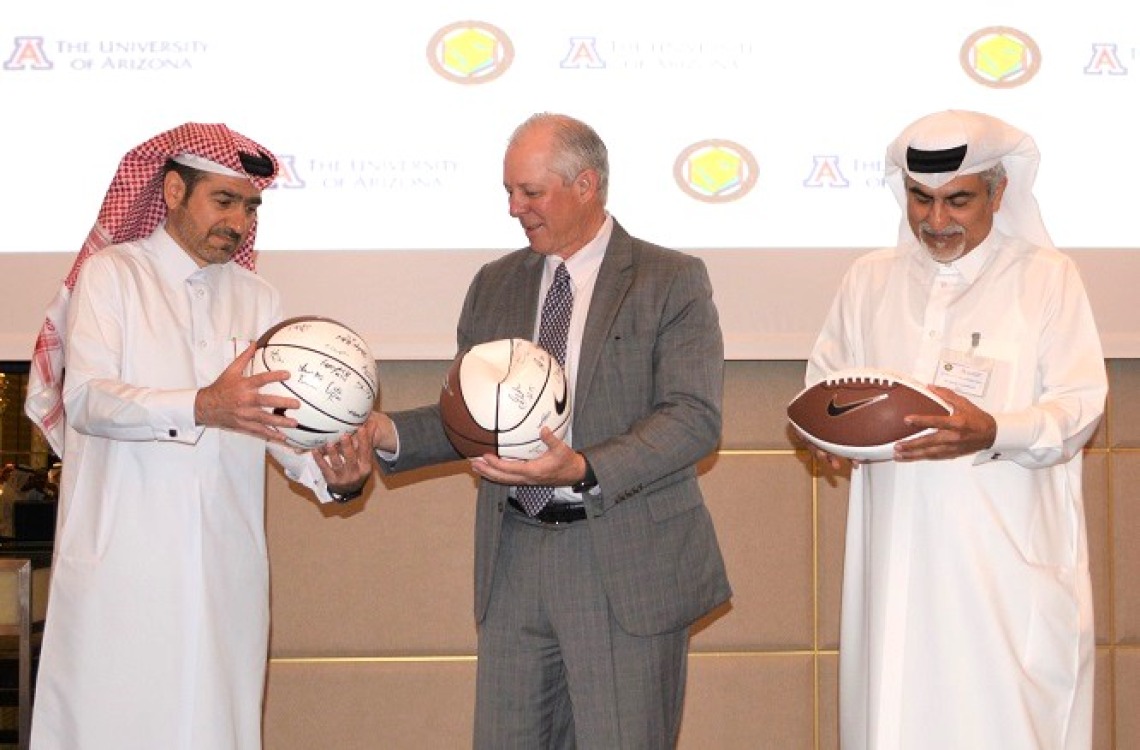President Robbins presents gifts to GCC Alumni