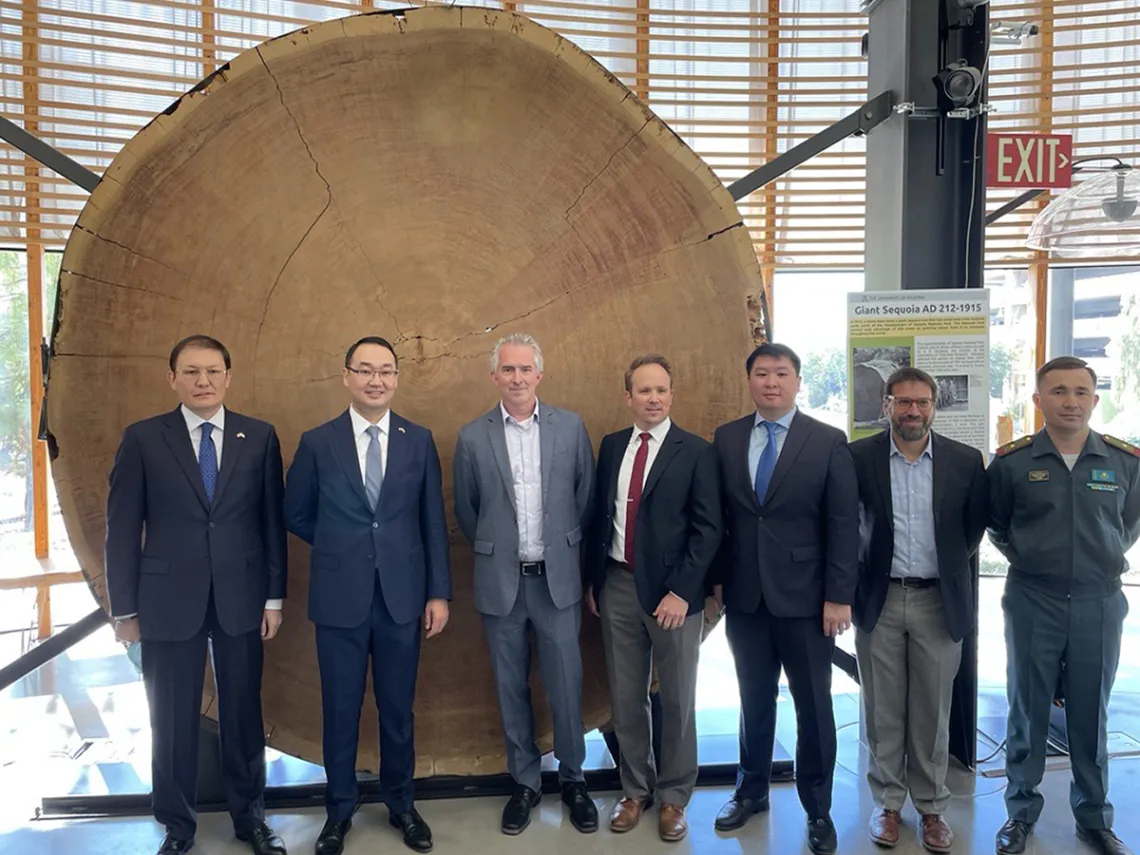 Laboratory of Tree Ring Research tour, in front of cross section of giant sequoi