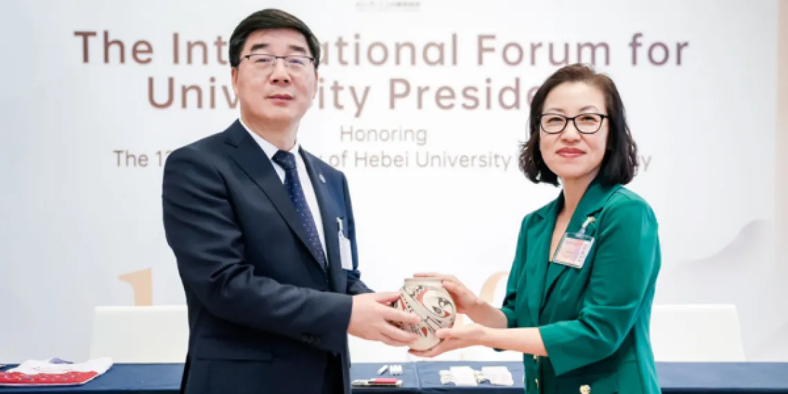 Vice President for Arizona International and Dean of International Education Dr. Jenny Lee presents Secretary Xu Han with an engraved Mata Ortiz pot