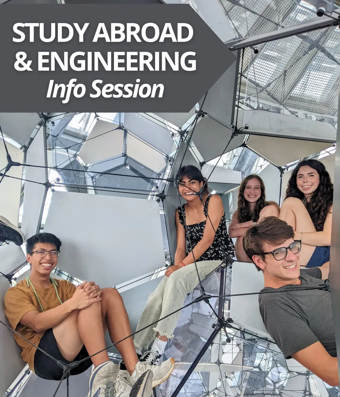 Engineering students in a geodesic structure smiling at the camera