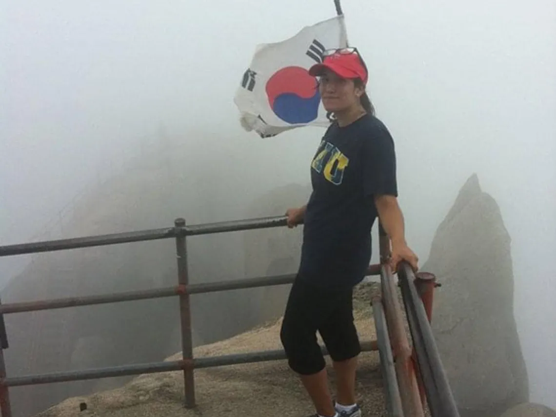 student in front of South Korean flag