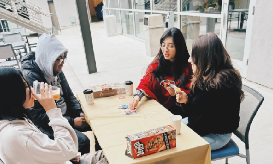 UArizona students playing a card game outside Arizona Global