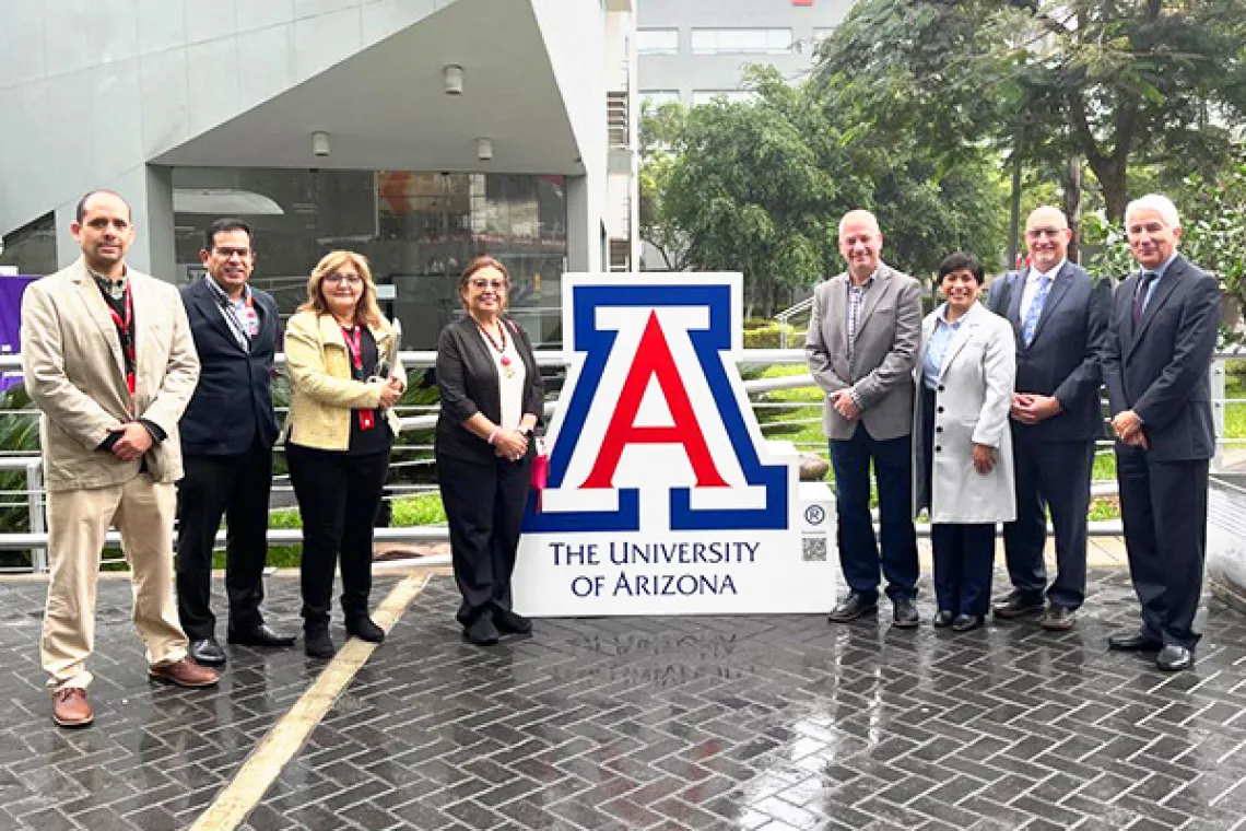 Representatives from UPC and UArizona gathered around a UArizona “Block A” on the UPC campus in Lima