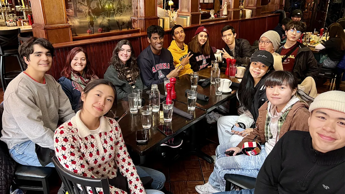 International students gather around a dinner table