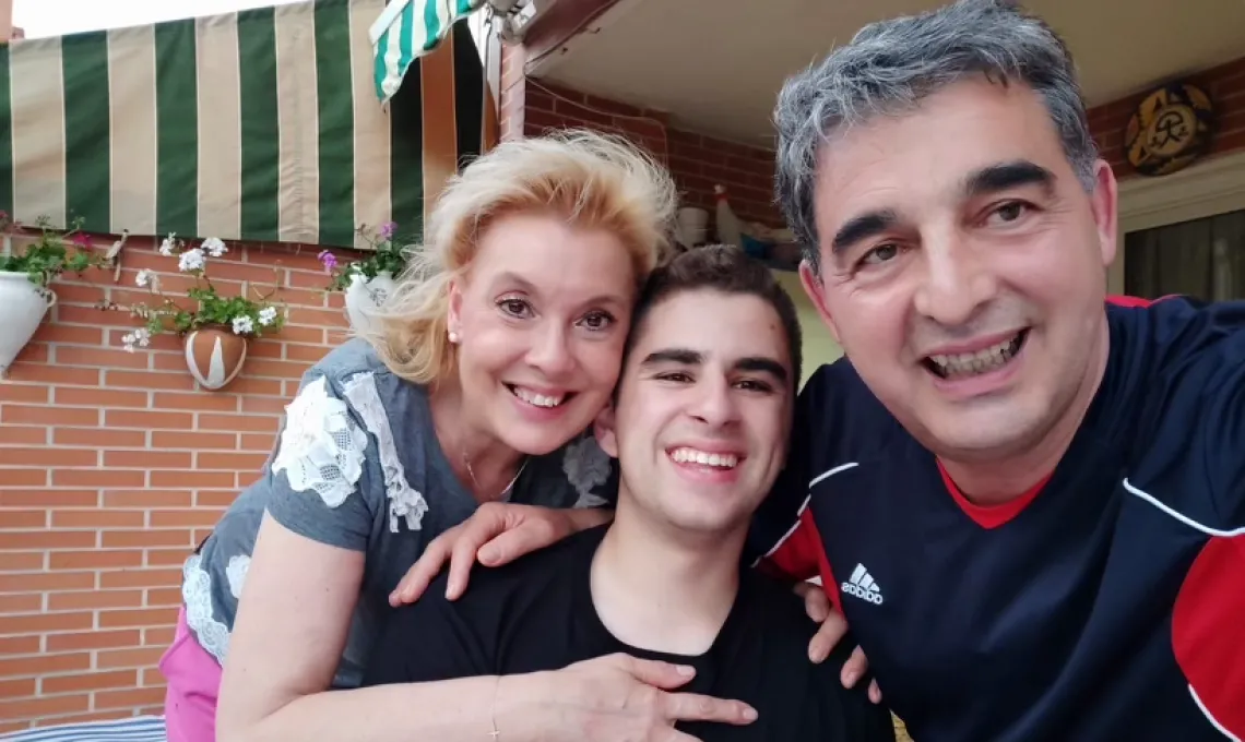 Study Abroad student Aaron takes a selfie with host family