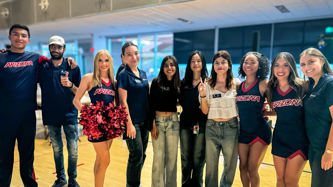 Global Ambassadors pose with U of A Cheerleaders