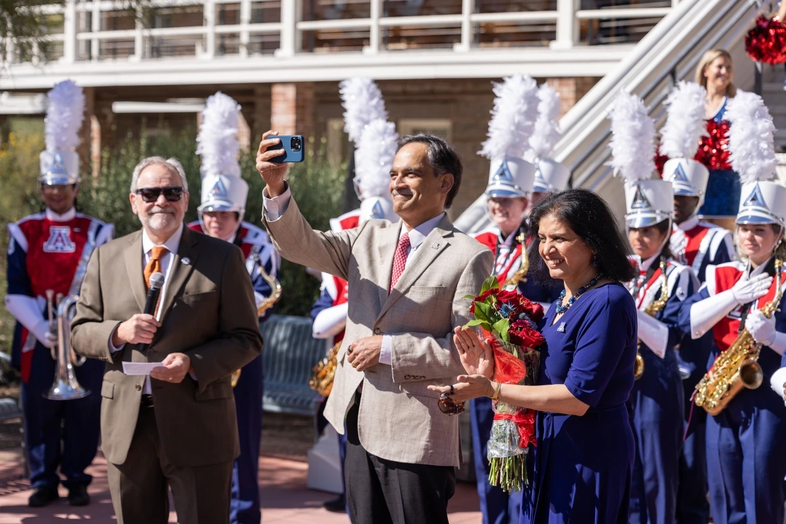 President Suresh Garimella takes a selfie with his wife, Lakshmi, in front of Old Main during an event welcoming him to campus.