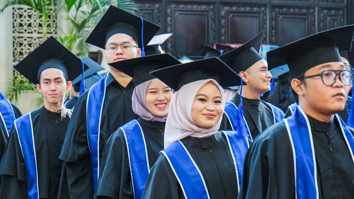 Sampoerna graduates in caps and gowns prepare for the ceremony.