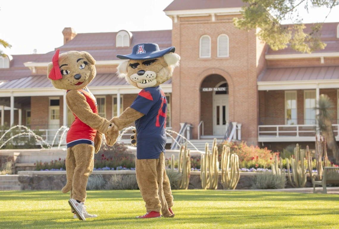 Wilbur and Wilma Wildcat in front of Old Main.