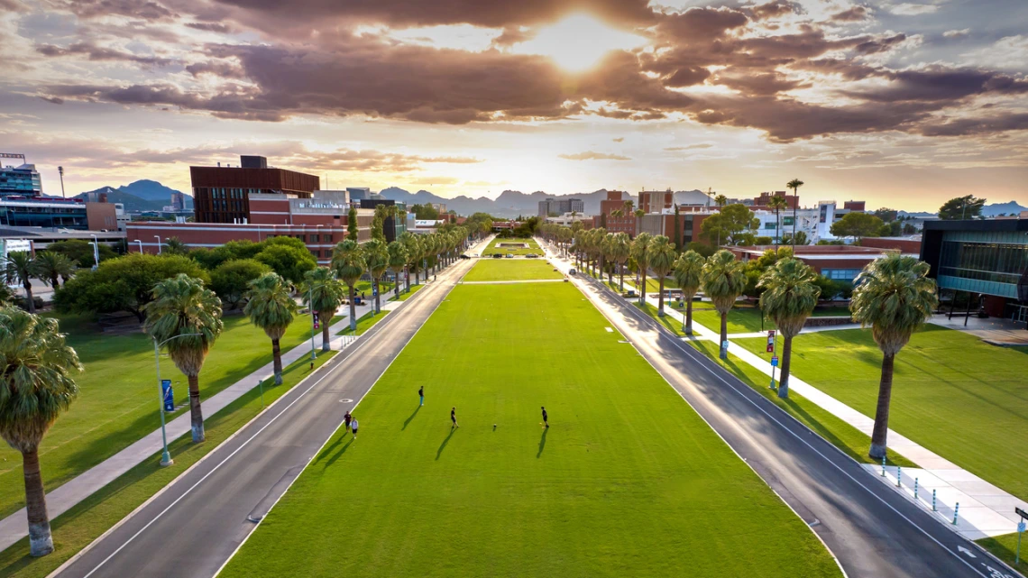 The University of Arizona grassy mall with the sunset in the background