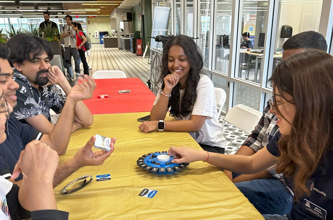 Students play a game around a table