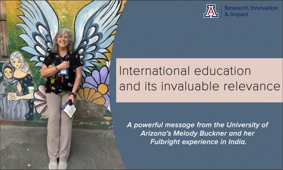 A smiling woman stands in front of a colorful mural featuring large angel wings and floral designs, creating the illusion that she has wings. She holds a pamphlet and wears a University of Arizona lanyard. To the right, a graphic overlay reads: “International education and its invaluable relevance” with a subheading, “A powerful message from the University of Arizona’s Melody Buckner and her Fulbright experience in India.” The design is branded with the U of A Research, Innovation & Impact logo, promoting g
