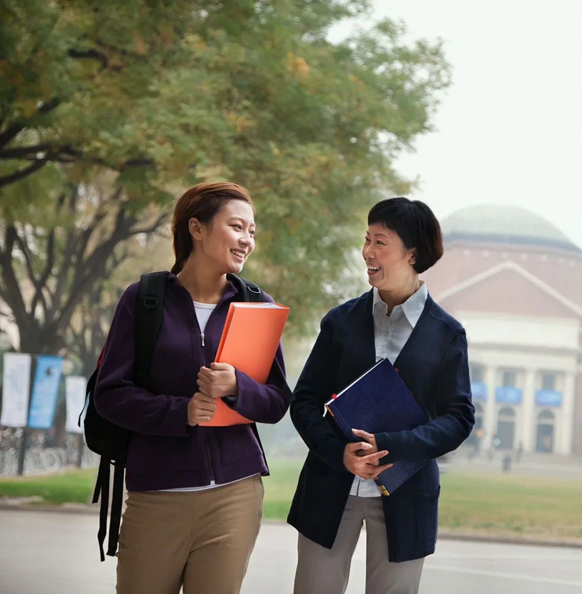 Student and professor walking on campus