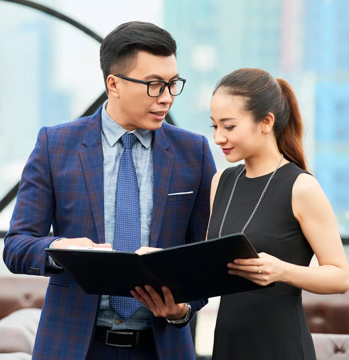 Business people examining a binder