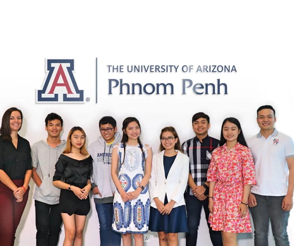 Students standing under Phnom Penh sign