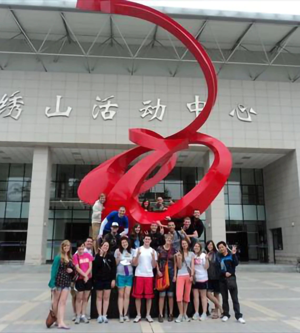 Students pose in front of building