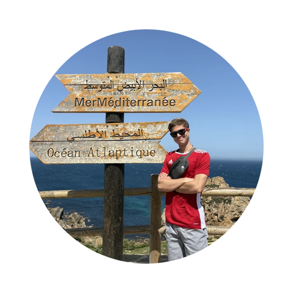 Student standing next to an antique road sign.