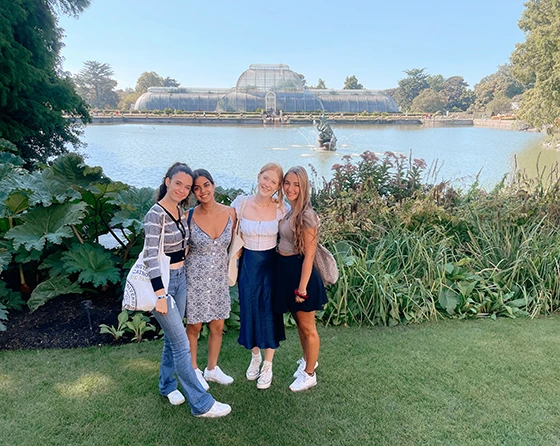 4 female students stand in Kew Gardens in London