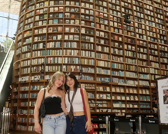 two students in a large library