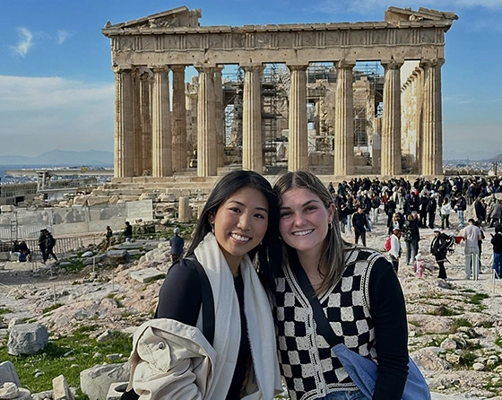 two female students in front of the acropolis