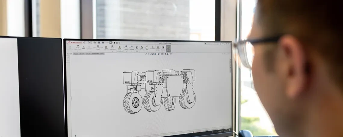 Student creating schematics on a computer