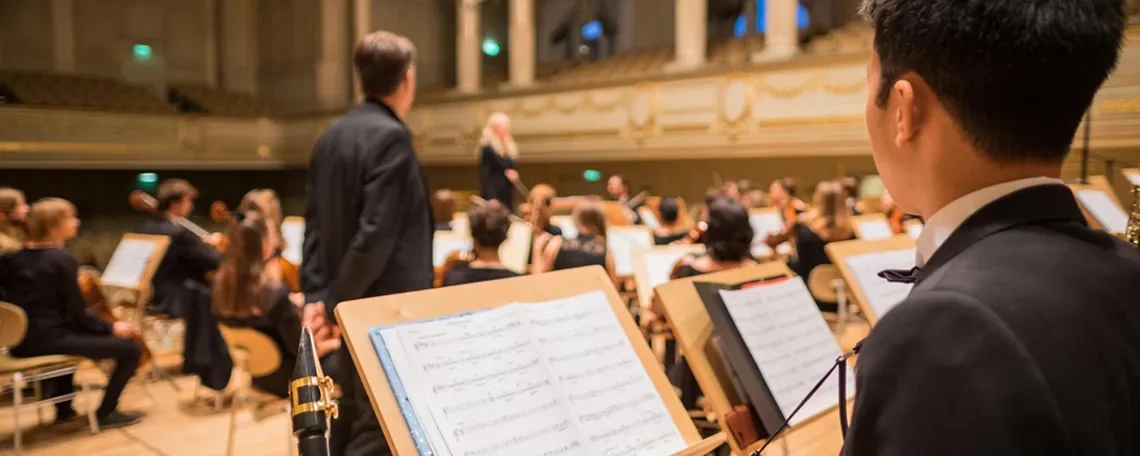 Conductor and orchestra practicing