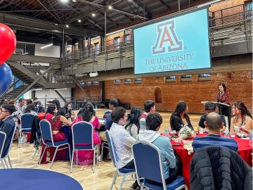 Vice President for Arizona International and Dean of International Education Dr. Jenny Lee address a crowd from a podium. 