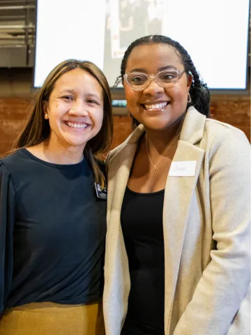 Associate Director of International Student Services Noelle Sallaz and student speaker Jennifer Gwasira pose together with smiles.  