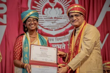 Dual degree graduate Megha poses with her award and Dr. Nair.