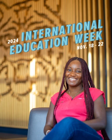 Student sits smiling at the camera while text on the image reads "2024 International Education Week Nov. 18-22"