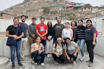 A group of students smile for the camera.